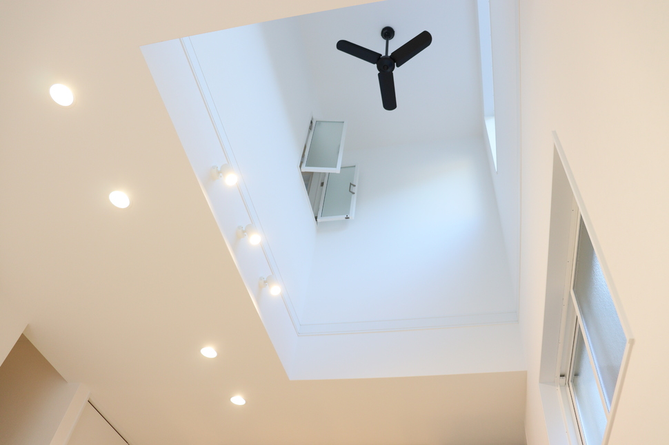 吹抜けとダウンライトで光が降り注ぐリビング